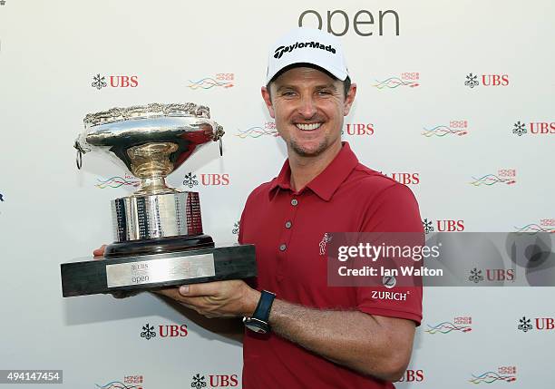 Justin Rose of England celebrates with the trophy after winning the final round of the UBS Hong Kong Open at The Hong Kong Golf Club on October 25,...