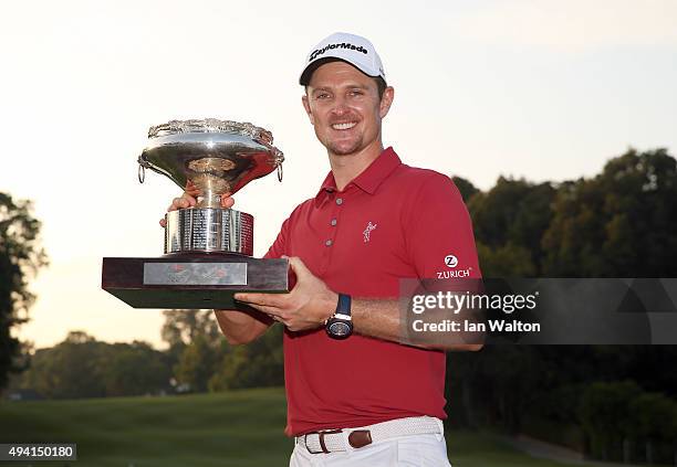 Justin Rose of England celebrates with the trophy after winning the final round of the UBS Hong Kong Open at The Hong Kong Golf Club on October 25,...