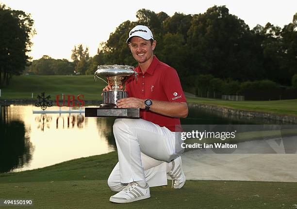 Justin Rose of England celebrates with the trophy after winning the final round of the UBS Hong Kong Open at The Hong Kong Golf Club on October 25,...