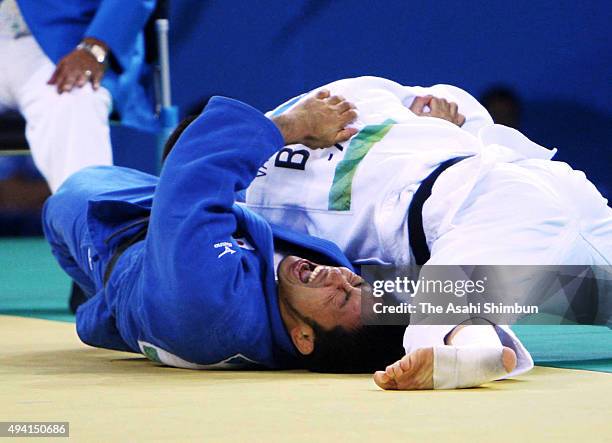 Dirk van Tichelt of Belgium and Yusuke Kanamaru of Japan compete in the Judo Men's -73kg Repechage semi final at the University of Science and...