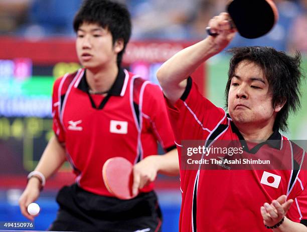 Seiya Kishikawa and Jun Mizutani of Japan compete in the table tennis team semi-final against Germany at the Peking University Gymnasium during day...