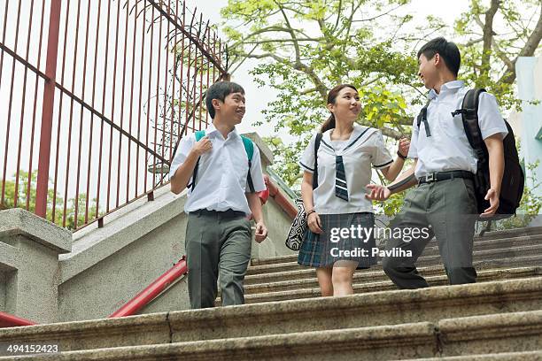 students walking in hong kong - bagpack stock pictures, royalty-free photos & images