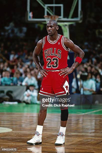 Michael Jordan of the Chicago Bulls stands on the court during a game against the Boston Celtics circa 1990 at the Boston Garden in Boston,...
