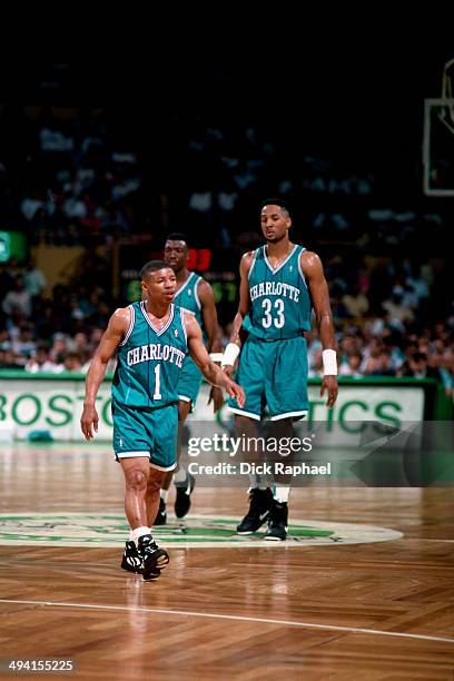 Muggsy Bogues and Alonzo Mourning of the Charlotte Hornets during the game against the Boston Celtics during a game played at the Boston Garden in...