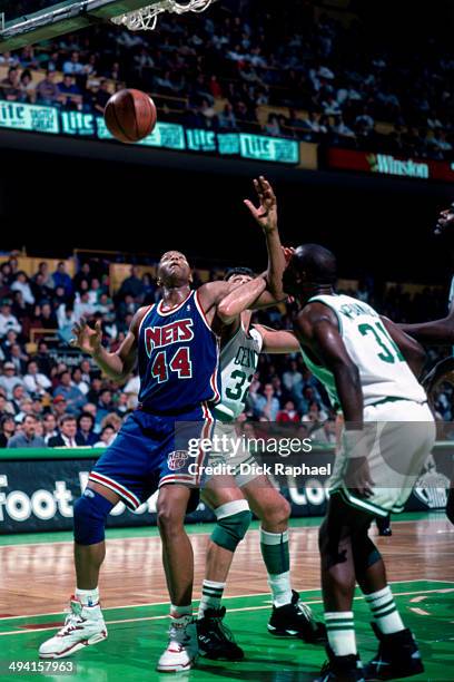 Derrick Coleman of the New Jersey Nets boxes-out Kevin McHale of the Boston Celtics during a game played at the Boston Garden in Boston,...