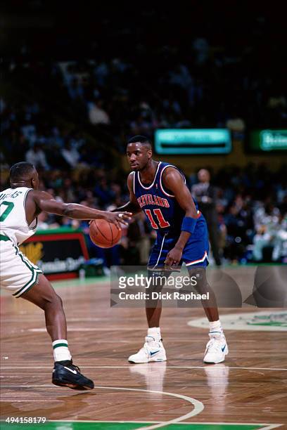 Terrell Brandon of the Cleveland Cavaliers handles the ball against Sherman Douglas of the Boston Celtics during a game played at the Boston Garden...
