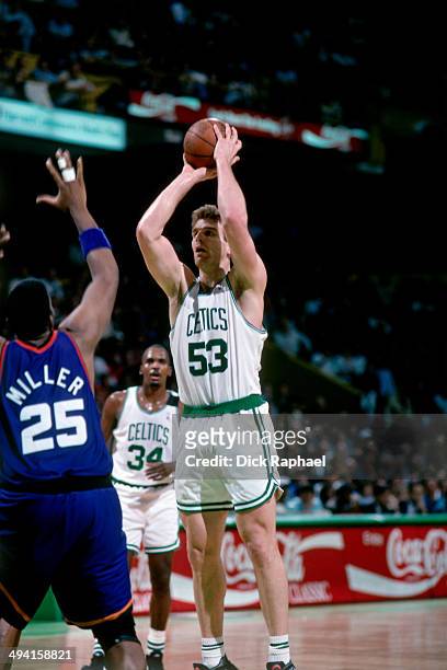 Joe Kleine of the Boston Celtics shoots against Oliver Miller of the Phoenix Suns during a game played at the Boston Garden in Boston, Massachusetts...