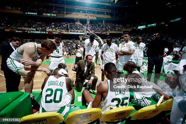 The Boston Celtics huddle around Head Coach Chris Ford during a timeout during a game played at the Boston Garden in Boston, Massachusetts circa...