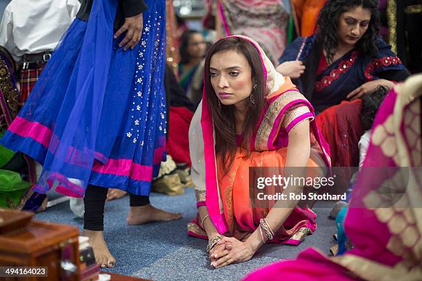 Hindu women pray in a temporary prayer hall at the Shree Swaminarayan Mandir, a major new Hindu temple being built in Kingsbury, before a visit by...