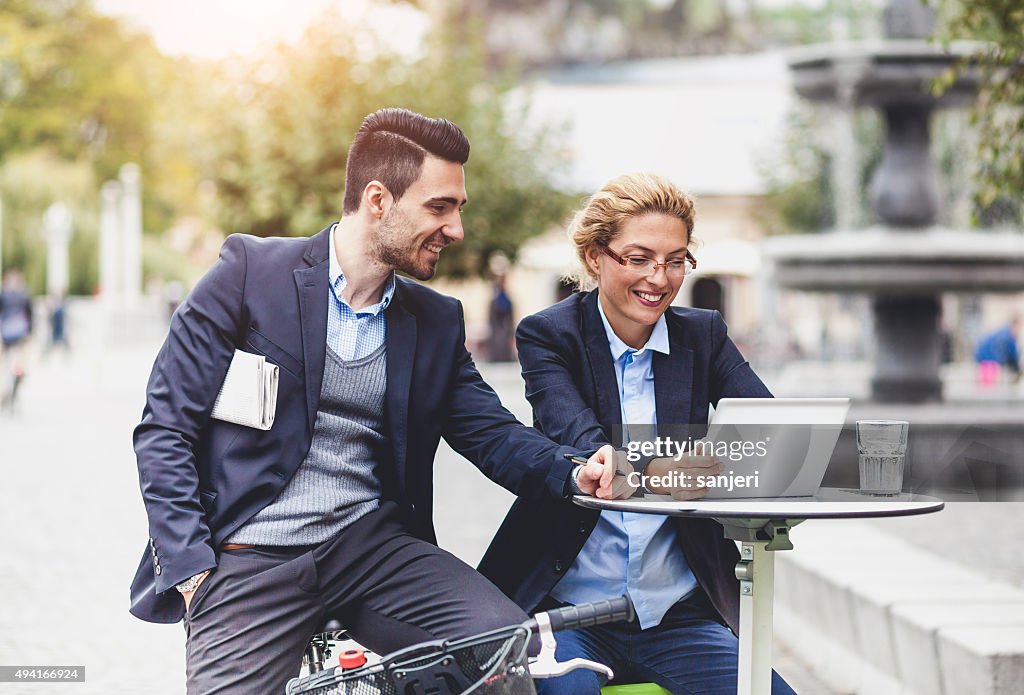 Business couple having meeting on the street