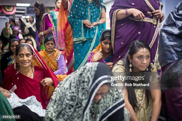 Women pray in a temporary prayer hall at the Shree Swaminarayan Mandir, a major new Hindu temple being built in Kingsbury, before a visit by Mayor of...