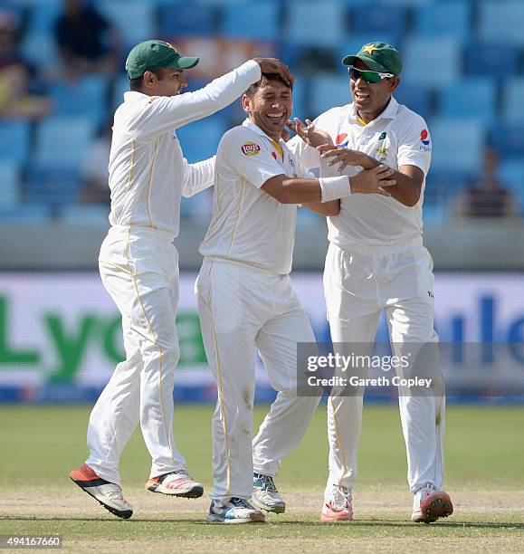 Yasir Shah of Pakistan celebrates with Asad Shafiq and Zulfiqar Babar after dismissing England captain Alastair Cook during day four of the 2nd test...