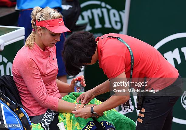 Sabine Lisicki of Germany receives treatment for an injury during her women's singles match against Mona Barthel of Germany on day four of the French...