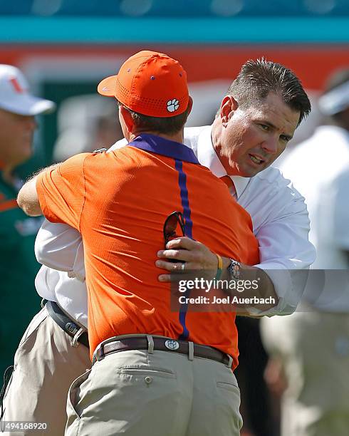 Head coach Al Golden of the Miami Hurricanes and head coach Dabo Swinney of the Clemson Tigers talk at midfield prior to the game on October 24, 2015...