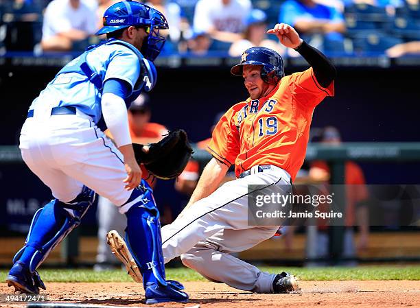 Robbie Grossman of the Houston Astros slides safely into home to score as catcher Brett Hayes of the Kansas City Royals is late applying the tag...