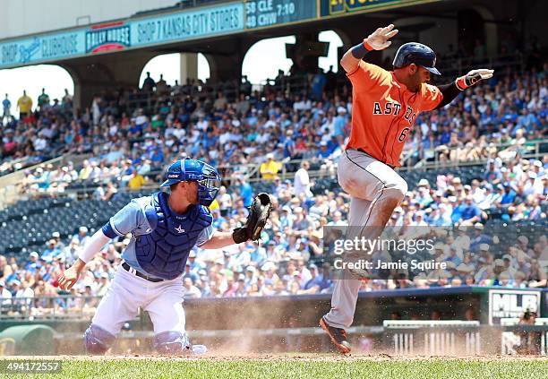 Jonathan Villar of the Houston Astros scores as catcher Brett Hayes of the Kansas City Royals is too late applying the tag during the 2nd inning of...