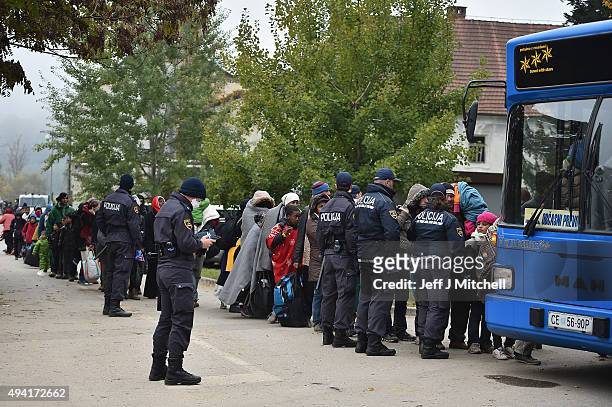 Migrants leave Brezice refugee camp to board buses as they continue they journey north towards Austria on October 25, 2015 in Brezice, Slovenia....