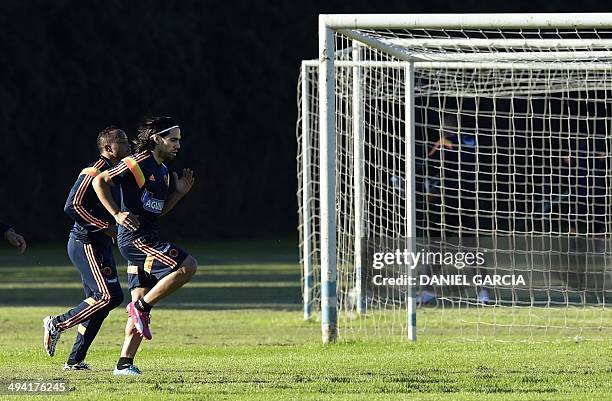 Colombia's national football team striker Radamel Falcao -- who is recovering from surgery on ruptured cruciate ligaments -- takes part in a training...