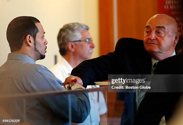 Carlos Ortiz, left, shakes hands with his defense attorney John Connors, during his arraignment hearing at Fall River Superior Court Tuesday, May 27...