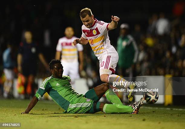 Elderson Echiejile of Nigeria tackles Shaun Maloney of Scotland during the International Friendly match between Nigeria and Scotland at Craven...