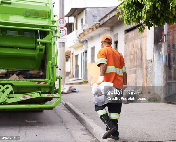 he's keeping our streets clean - vuilnisman stockfoto's en -beelden