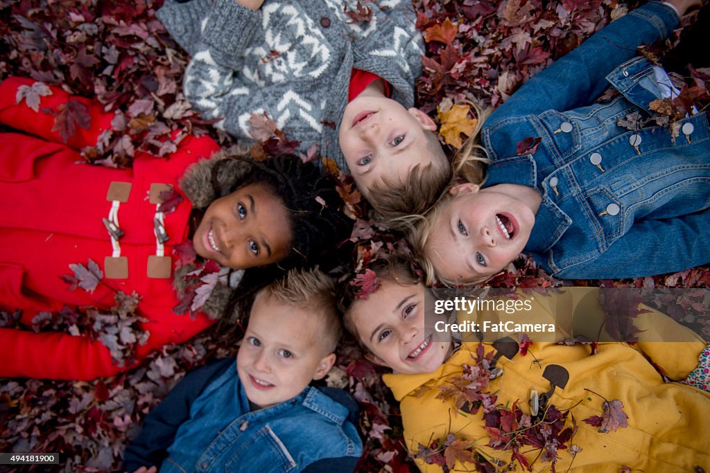 Children Lying in a Circle in the Leaves