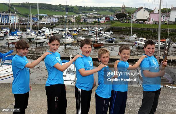 In this handout image provided by Glasgow 2014 Ltd, Batonbearers Lauren Walsh, Ruth Davies, Ioan Lewis, Daniel Owen, Gwion Payne, Shane Davies, hold...