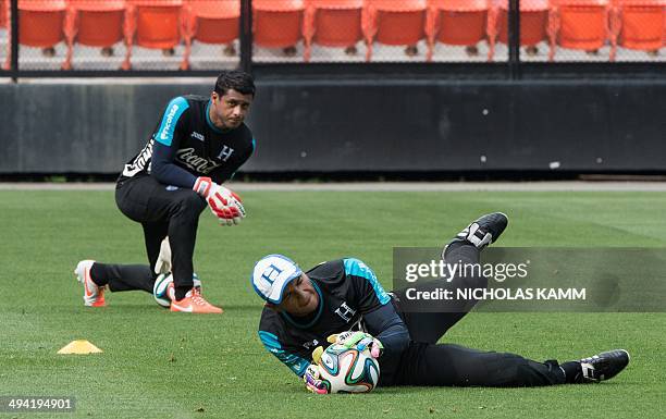 Honduras national team goalkeeper Donis Escober makes a save as fellow goalkeeper Noel Valladares looks on during a training session in Washington on...