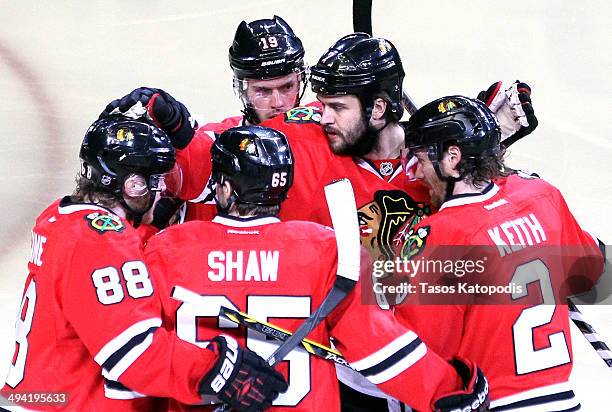 Brent Seabrook of the Chicago Blackhawks celebrates with his teammates after scoring a goal on Jonathan Quick of the Los Angeles Kings in the first...