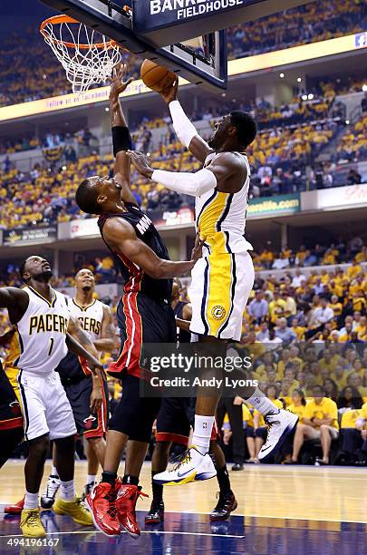 Roy Hibbert of the Indiana Pacers goes to the basket as Chris Bosh of the Miami Heat defends during Game Five of the Eastern Conference Finals of the...