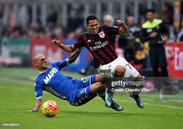 Carlos Bacca of AC Milan and Paolo Cannavaro of US Sassuolo Calcio compete for the ball during the Serie A match between AC Milan and US Sassuolo...