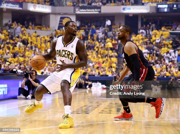 Lance Stephenson of the Indiana Pacers controls the ball as Dwyane Wade of the Miami Heat defends during Game Five of the Eastern Conference Finals...