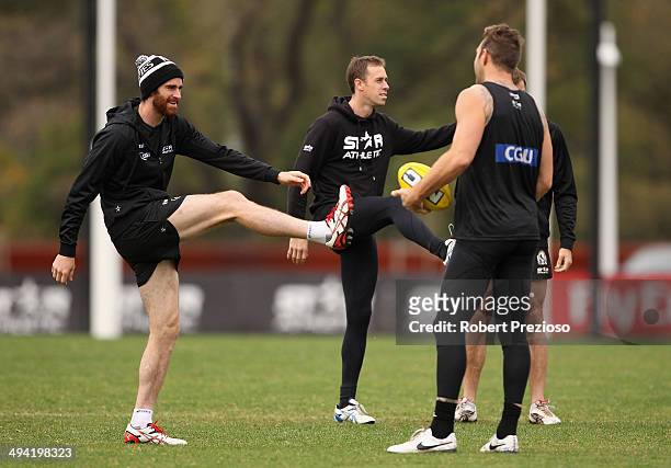Nick Maxwell stretches during a Collingwood Magpies AFL training session at Olympic Park on May 29, 2014 in Melbourne, Australia.