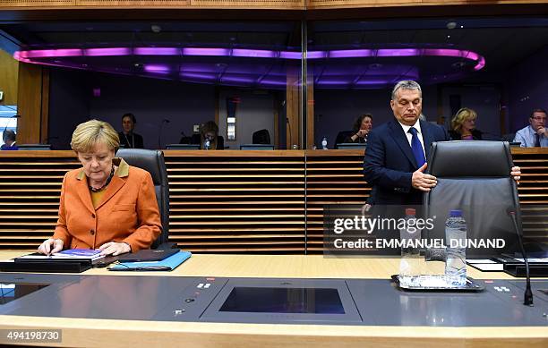 Germany's Chancellor Angela Merkel looks on as Hungary's Prime Minister Viktor Orban takews his seat for a European leader's meeting on refugee flows...