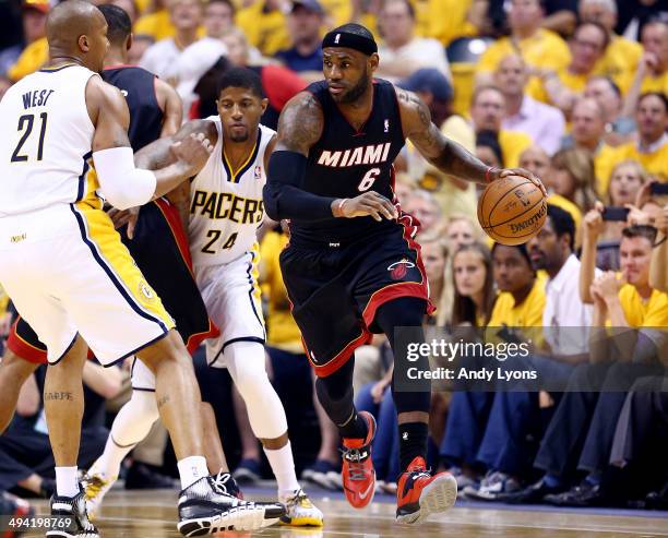 LeBron James of the Miami Heat controls the ball as David West of the Indiana Pacers defends during Game Five of the Eastern Conference Finals of the...