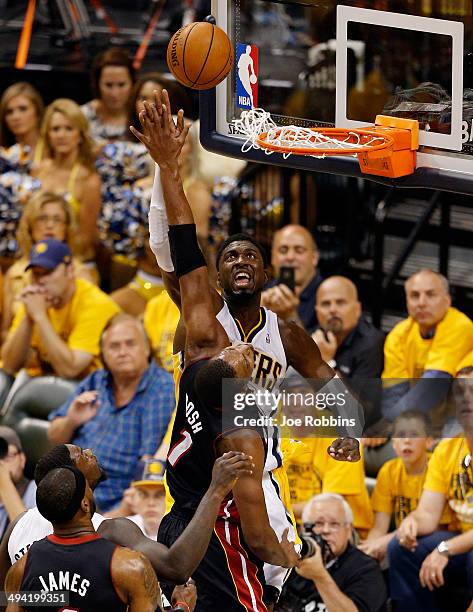 Roy Hibbert of the Indiana Pacers goes to the basket as Chris Bosh of the Miami Heat defends during Game Five of the Eastern Conference Finals of the...