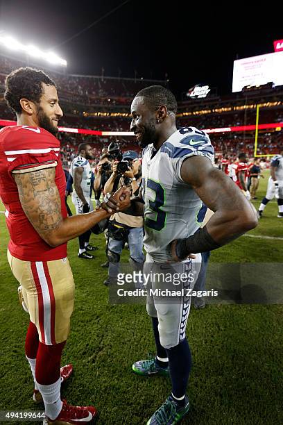 Colin Kaepernick of the San Francisco 49ers and Ricardo Lockette of the Seattle Seahawks talk on the field following the game at Levi Stadium on...