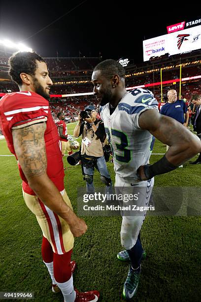 Colin Kaepernick of the San Francisco 49ers and Ricardo Lockette of the Seattle Seahawks talk on the field following the game at Levi Stadium on...