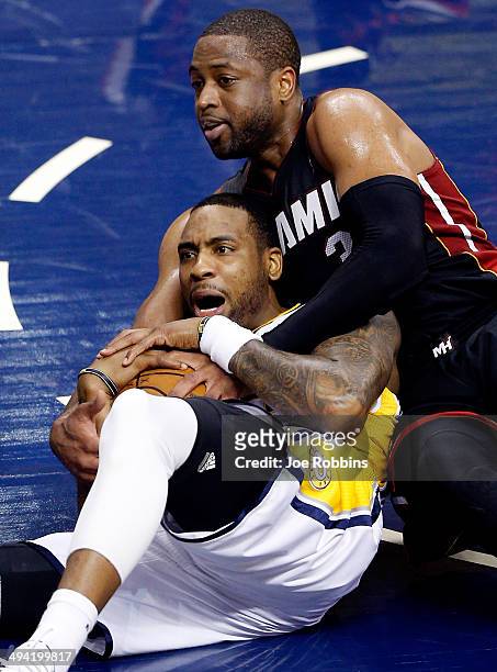 Rasual Butler of the Indiana Pacers and Dwyane Wade of the Miami Heat battle for a loose ball during Game Five of the Eastern Conference Finals of...