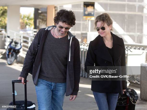 Doyle Bramhall II and Renee Zellweger are seen at Los Angeles International Airport on February 10, 2013 in Los Angeles, California.