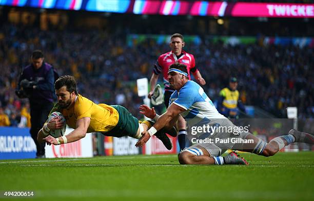 Adam Ashley-Cooper of Australia dives over to scores his sides second try despite the tackle by Pablo Matera of Argentina during the 2015 Rugby World...