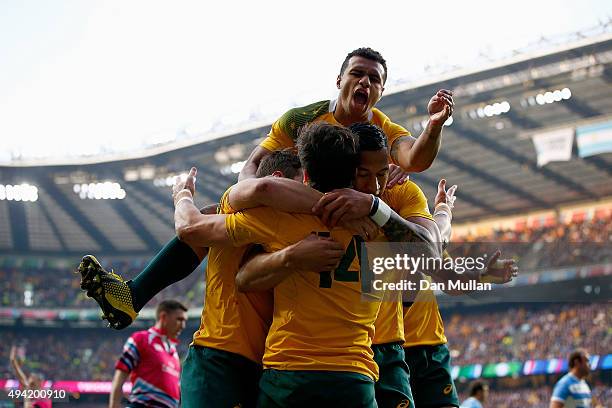 Adam Ashley-Cooper of Australia celebrates with teammates after scoring his sides second try during the 2015 Rugby World Cup Semi Final match between...