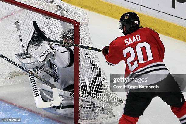 Jonathan Quick of the Los Angeles Kings makes a save against Brandon Saad of the Chicago Blackhawks in the second period during Game Five of the...