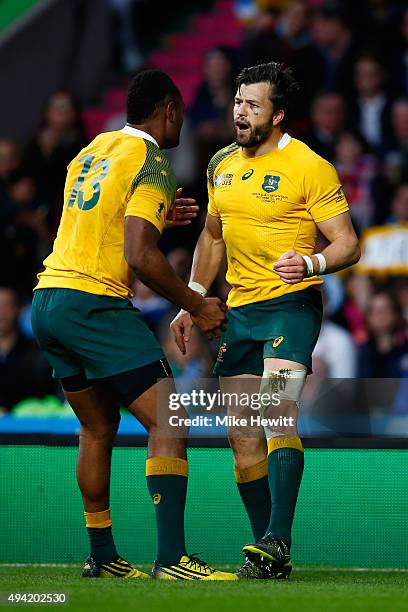 Adam Ashley-Cooper celebrates with Tevita Kuridrani of Australia celebrates scoring his sides third try during the 2015 Rugby World Cup Semi Final...