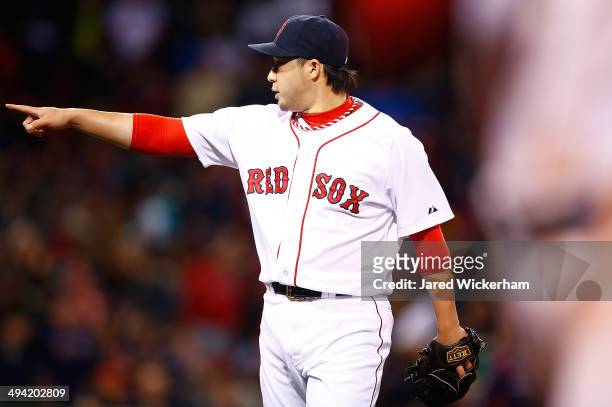 Junichi Tazawa of the Boston Red Sox reacts after pitching against the Atlanta Braves in the 8th inning during the game at Fenway Park on May 28,...
