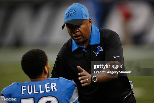 Head coach Jim Caldwell of the Detroit Lions talks to Corey Fuller prior to playing the Minnesota Vikings at Ford Field on October 25, 2015 in...