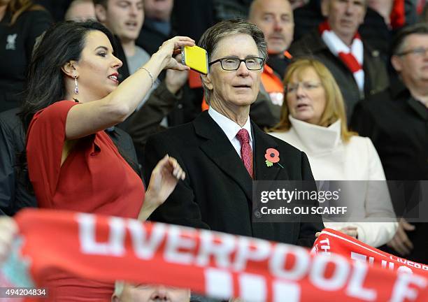 Liverpool's US owner John W. Henry's wife Linda Pizzuti takes a photograph during the English Premier League football match between Liverpool and...