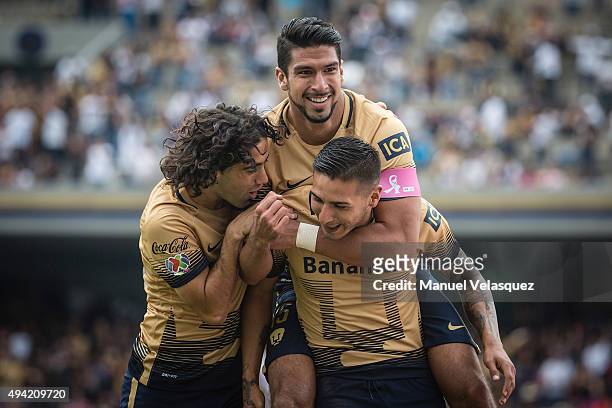 Eduardo Herrera of Pumas celebrates with Ismael Sosa and Matias Britos after socirng the first goal of his team during the 14th round match between...