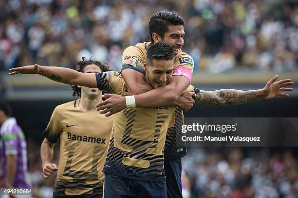 Eduardo Herrera of Pumas celebrates with teammate Ismael Sosa after scoring the first goal of his team during the 14th round match between Pumas UNAM...