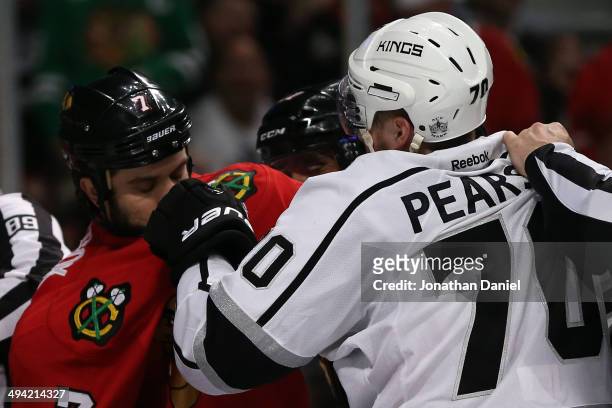 Tanner Pearson of the Los Angeles Kings fights with Brent Seabrook of the Chicago Blackhawks during Game Five of the Western Conference Final in the...